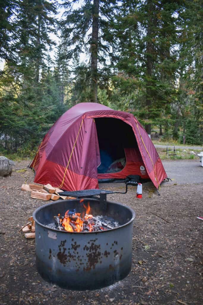 red tent set up near campfire pit