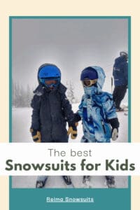 two kids skiing in snowsuits.